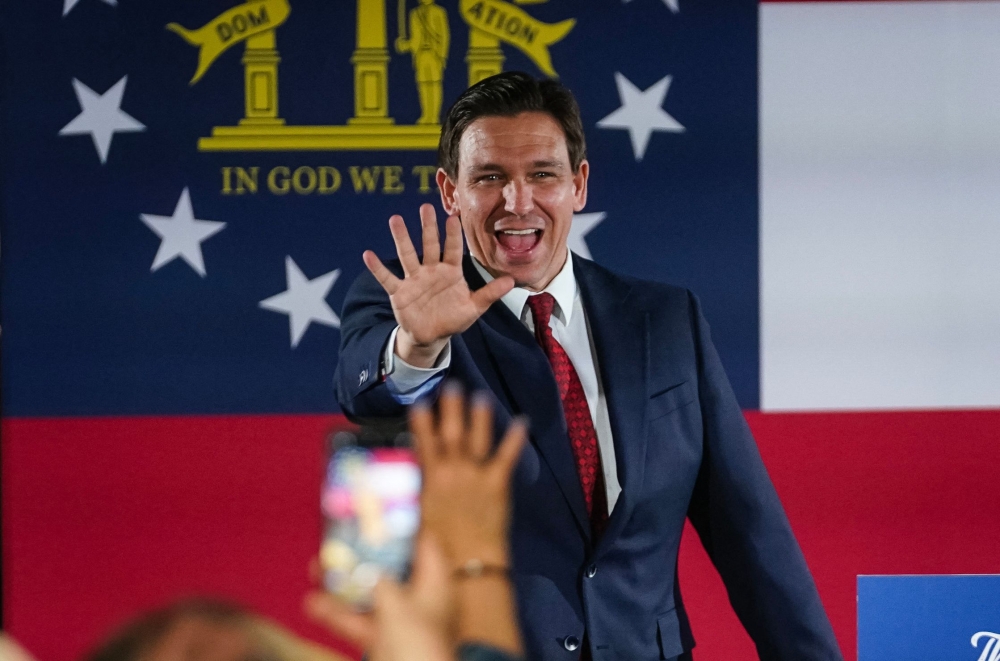 Florida Governor Ron DeSantis greets attendees as he arrives at an event on his nationwide book tour, at Adventure Outdoors, the largest gun store in the country, on March 30, 2023, in Smyrna, Georgia. — AFP pic