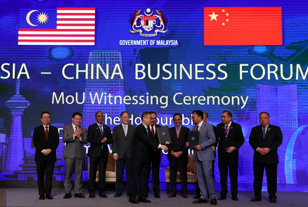 Prime Minister Datuk Seri Anwar Ibrahim (5th right) witnesses the signing ceremony of the Heads of Agreement between DRB-Hicom Berhad and Zhejiang Geely Holding Group Co Ltd during the Malaysia-China Business Forum 2023 in Bejing April 1, 2023. — Bernama pic