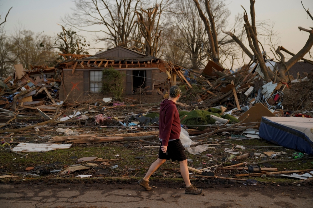 Tim Tucker walks past the wreckage of his home in the aftermath of a tornado, after a monster storm system tore through the South and Midwest on Saturday, in Wynne, Arkansas, US April 1, 2023. — Reuters pic