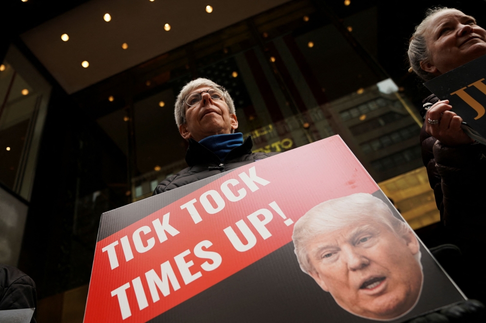 File photo of an anti-Trump protester holds a placard outside Trump Tower after former US President Donald Trump’s indictment by a Manhattan grand jury following a probe into hush money paid to porn star Stormy Daniels, in New York City, US, March 31, 2023. — Reuters pic