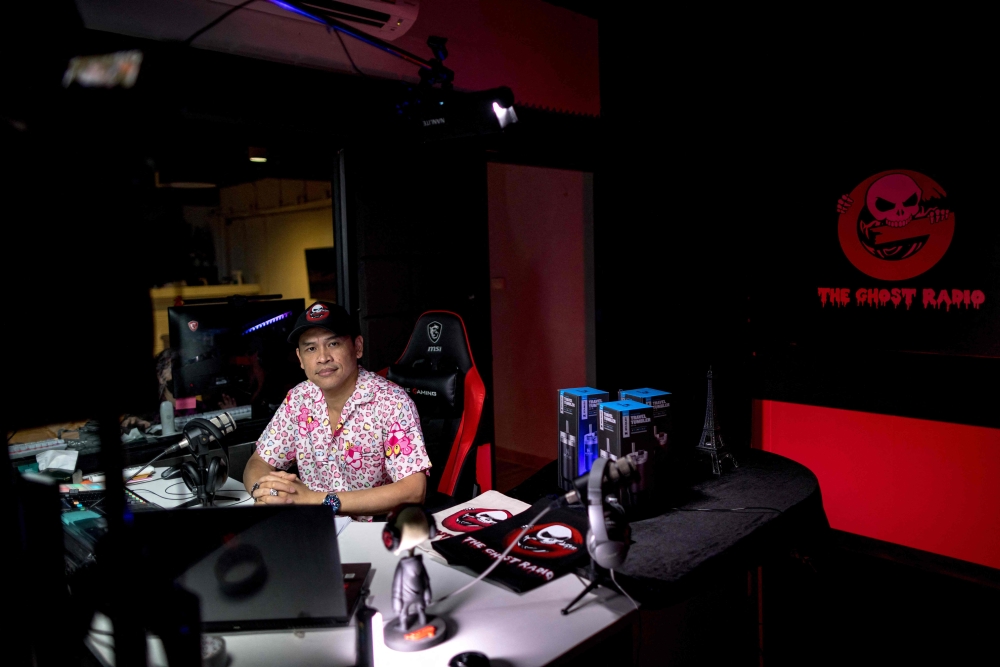 Ghost Radio station host Jack Watcharaphon poses in his studio in Bangkok. — AFP pic