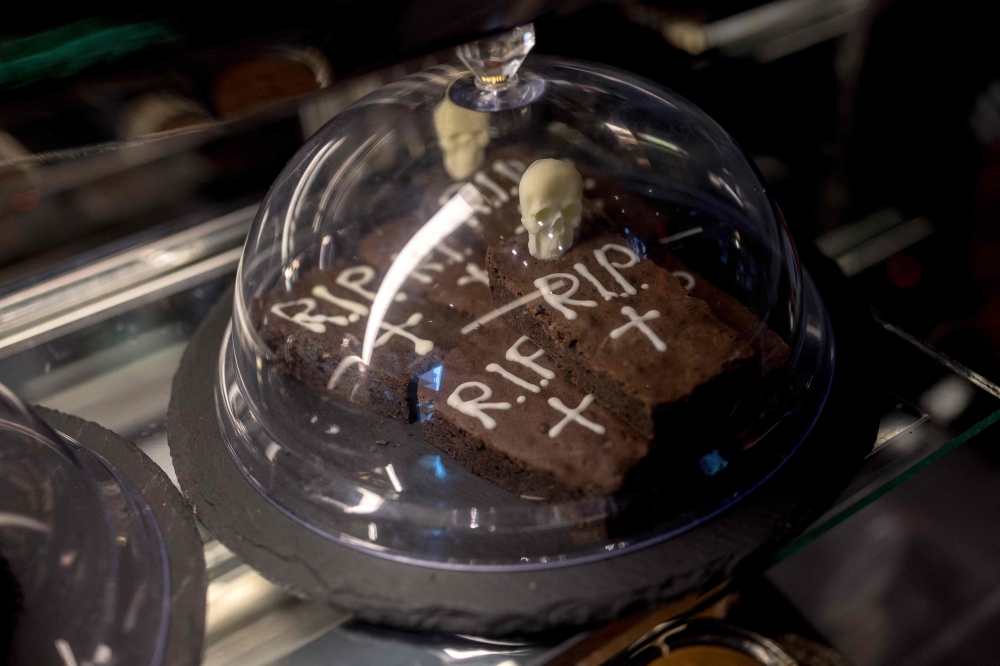 Chocolate brownies are displayed in the Ghost House cafe. — AFP pic