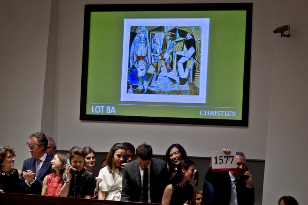 A Christie's employee holds up the winning paddle number for Pablo Picasso's 'The Women of Algiers (Version 'O')' at Christie's Auction House in New York May 11, 2015. — Reuters pic
