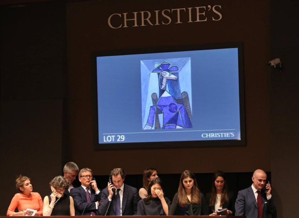 Christie's employees look on as a moderator facilitates the sale of an artwork titled 'Portrait de femme (Dora Maar)' by artist Pablo Picasso during a Christie's auction in New York May 6, 2014. — Reuters pic