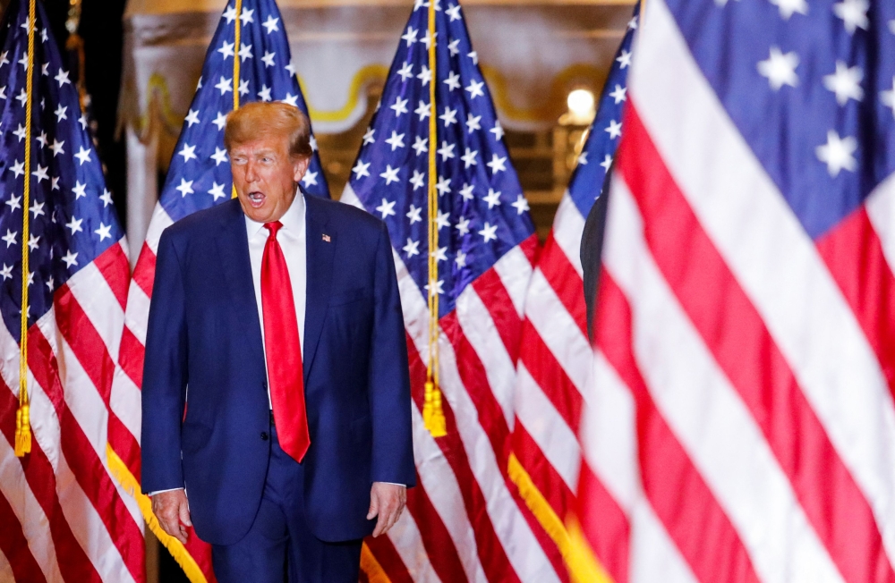 Former US President Donald Trump walks on the day of his court appearance in New York after being indicted by a Manhattan grand jury following a probe into hush money paid to porn star Stormy Daniels, in Palm Beach, Florida April 4, 2023. — Reuters pic