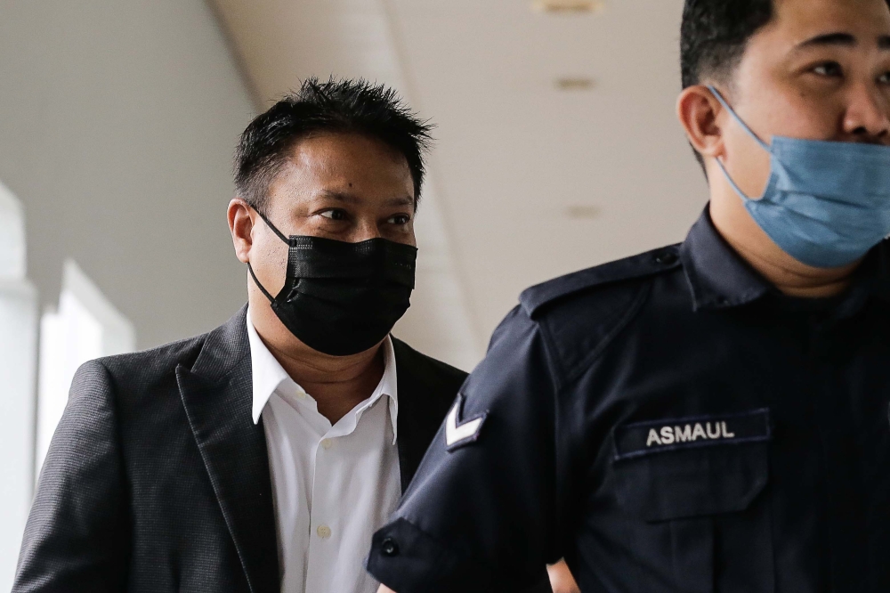 Abdul Hamid Shaikh Abdul Razak Shaikh (left) pleaded not guilty when charges were read out to him where he stands accused of offering RM500,000 per year for a 15-year period to the former communications and multimedia minister in return for him to speed up the approvals for his company to handle concessions for the KL Tower. — Picture by Sayuti Zainudin