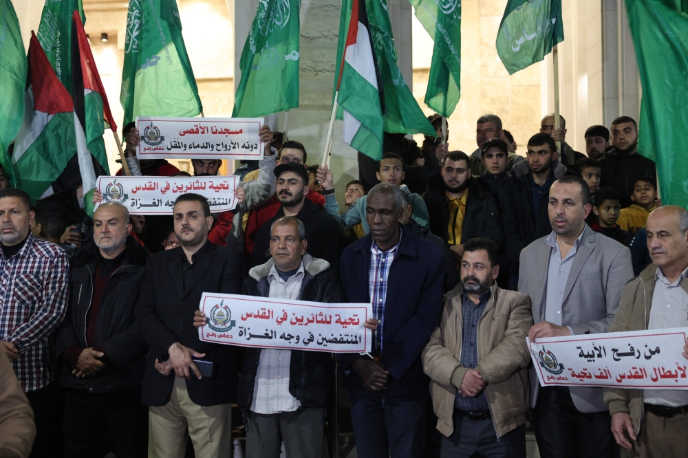 Hamas movement supporters carry placards as well as party and national flags during a rally organised by the Islamist group that rules the Gaza Strip in the southern city of Rafah in solidarity with Jerusalem's Al-Aqsa Mosque April 5, 2023. — AFP pic