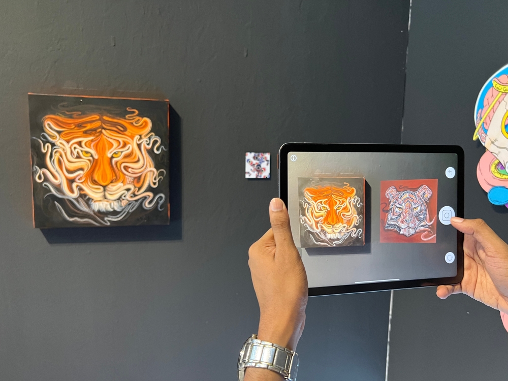 HARIMAU #0100MY by Christine Das, with the accompanying AR piece, HARIMAU #0099MY (on the Apple iPad), are displayed at the Hin Bus Depot in George Town. — Picture by Opalyn Mok