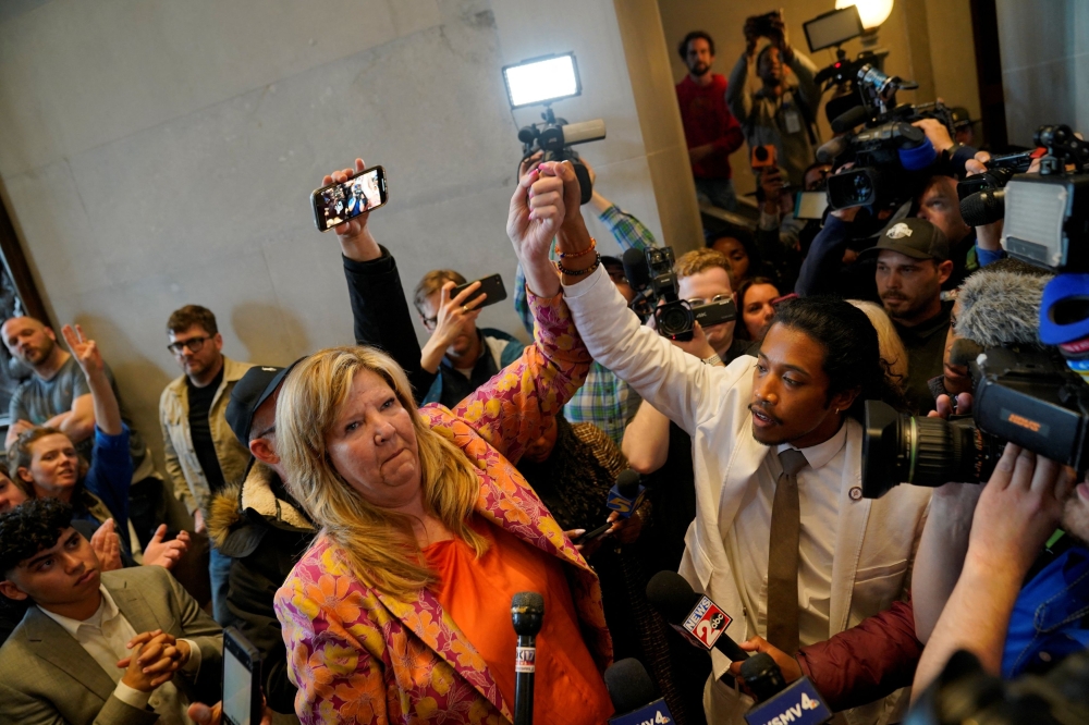 Justin Jones and Rep. Gloria Johnson hold their hands up after a vote at the Tennessee House of Representatives to expel him for his role in a gun control demonstration at the statehouse last week, in Nashville, Tennessee April 6, 2023. — Reuters pic