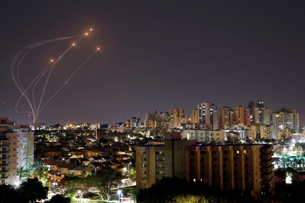 Streaks of light are seen as Israel's Iron Dome anti-missile system intercept rockets launched from the Gaza Strip, as seen from Ashkelon April 7, 2023. — Reuters pic