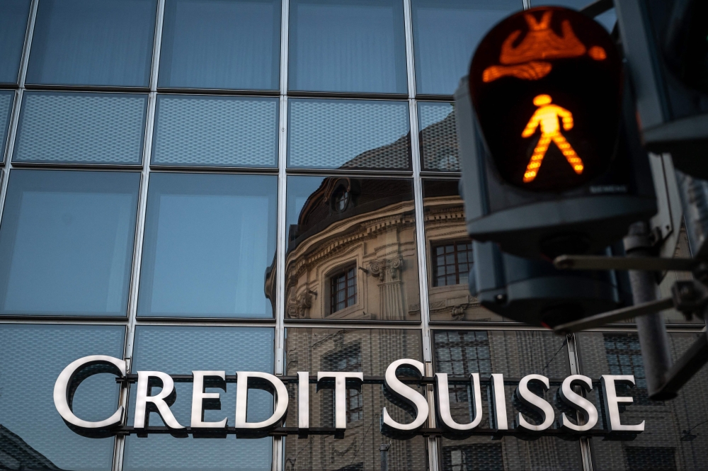 A sign of Swiss bank Credit Suisse is seen in Basel, on the eve of the general meeting of shareholders following the takeover by UBS of Credit Suisse hastily arranged by the Swiss government to prevent a financial meltdown. — AFP pic