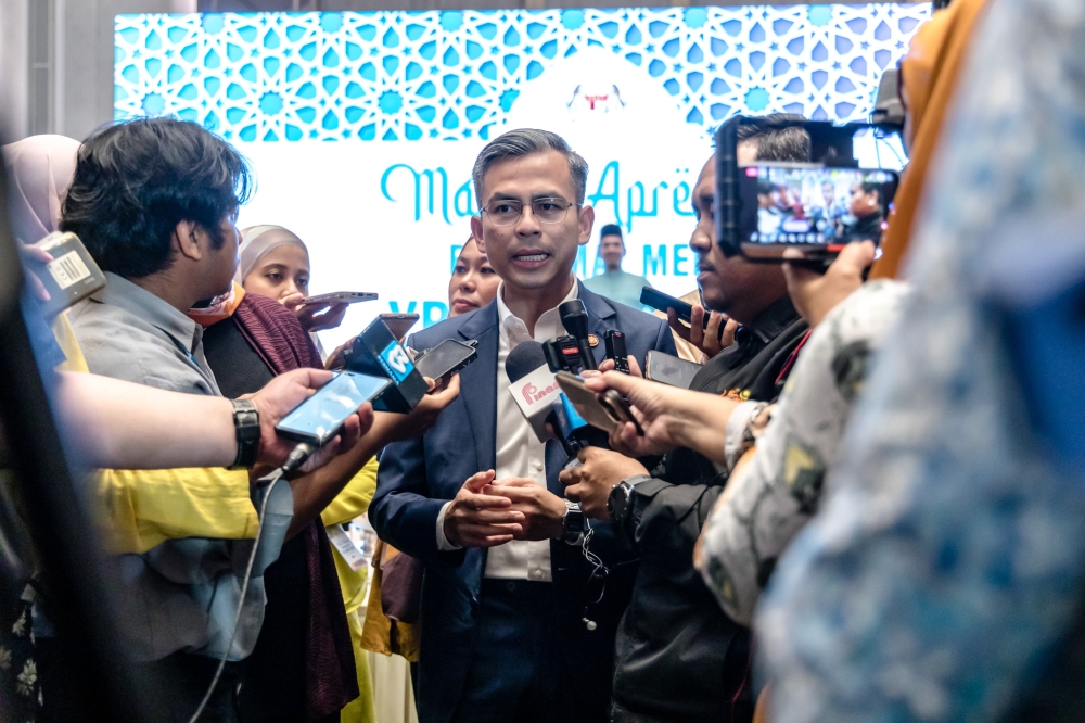 Communications and Digital Minister Fahmi Fadzil urged Malaysians to make sure to verify identities of those who contact them, in order to avoid getting scammed.  — Picture by Firdaus Latif