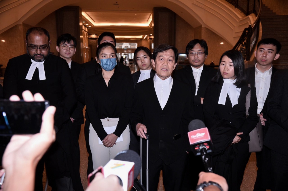 Lawyer Hisyam Teh Poh Teik (fourth right) with Sam Ke Ting (third left) during a press conference after the court ruled in favour of his client, at the Court of Appeal in Putrajaya.
