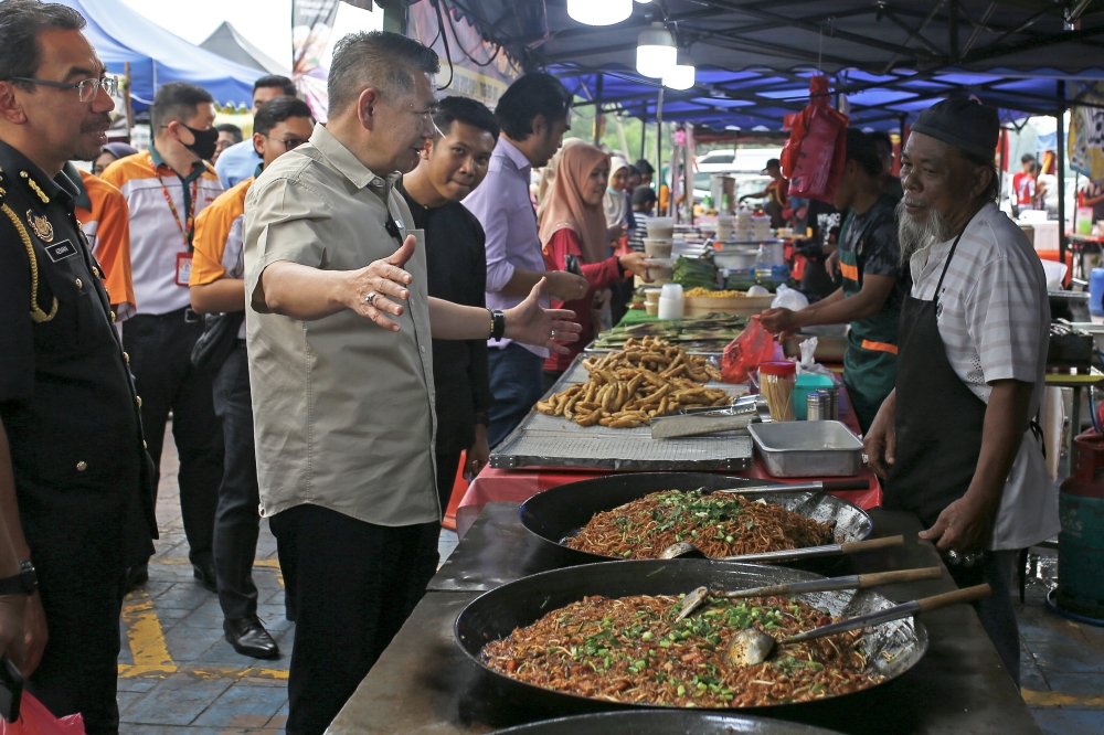 Domestic Trade and Cost of Living Minister Datuk Seri Salahuddin Ayub is seen during a walkabout at the Rahmah Ramadan Bazaar in Seremban April 11, 2023. — Bernama pic