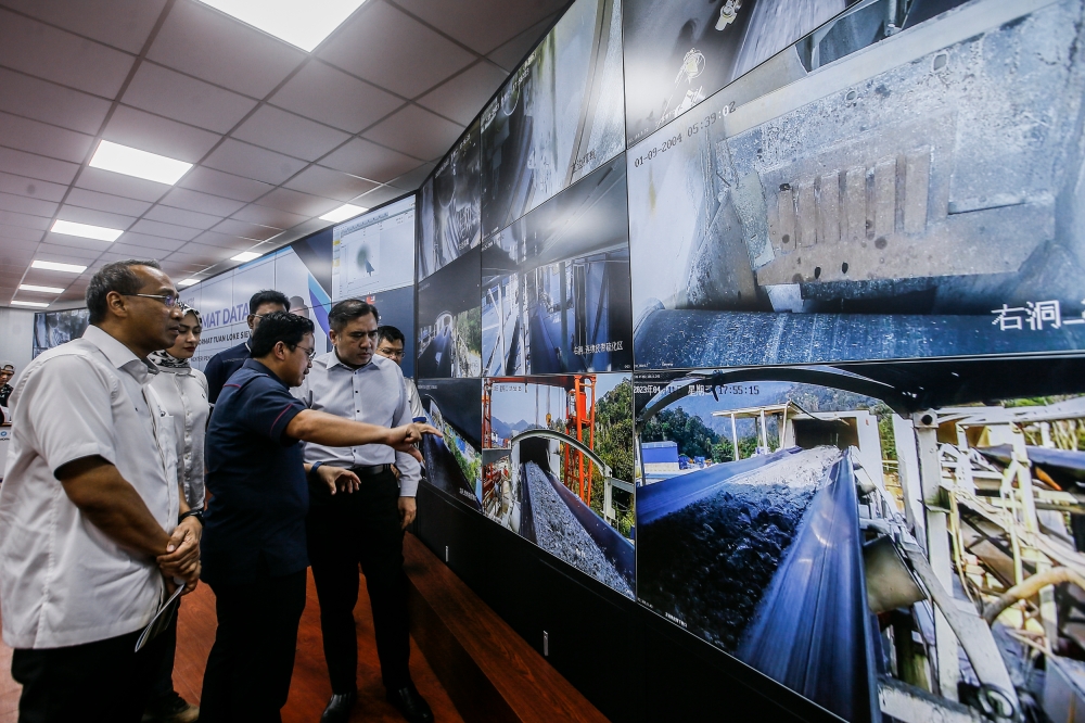Transport Minister Anthony Loke (right) listens to a briefing from Malaysia Rail Link Sdn Bhd (MRL) CEO Datuk Seri Darwis Abdul Razak during a working visit to the Genting ECRL tunnel construction site in Bentong April 11, 2023. — Picture by Hari Anggara