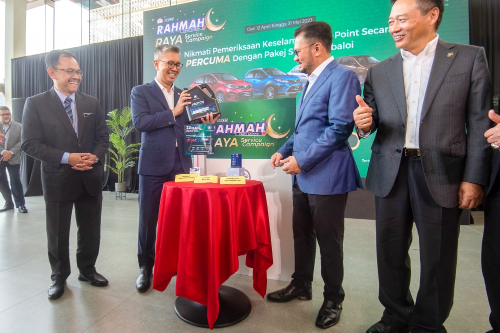Datuk Seri Tengku Zafrul Abdul Aziz (2nd left) and Proton chairman, Datuk Seri Syed Faisal Albar officiating the launch of the 2023 Proton Rahmah Campaign at Proton 3S Platinum Flagship Outlet, IOI City Mall, Putrajaya April 12, 2023. —  Picture by Shafwan Zaidon