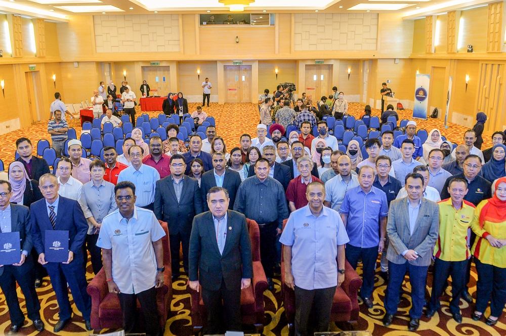 Minister of Transport, Anthony Loke posing with representatives during the Interim Stage Bus Support Fund signing ceremony at Putrajaya, April 13, 2023. — Picture by Miera Zulyana