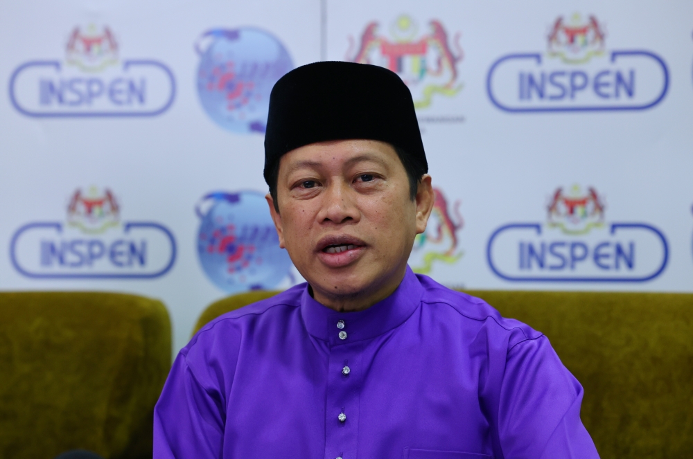 Deputy Finance Minister Datuk Seri Ahmad Maslan speaks during a press conference after visiting the Valuation and Property Management Department in Putrajaya April 14, 2023. — Bernama pic