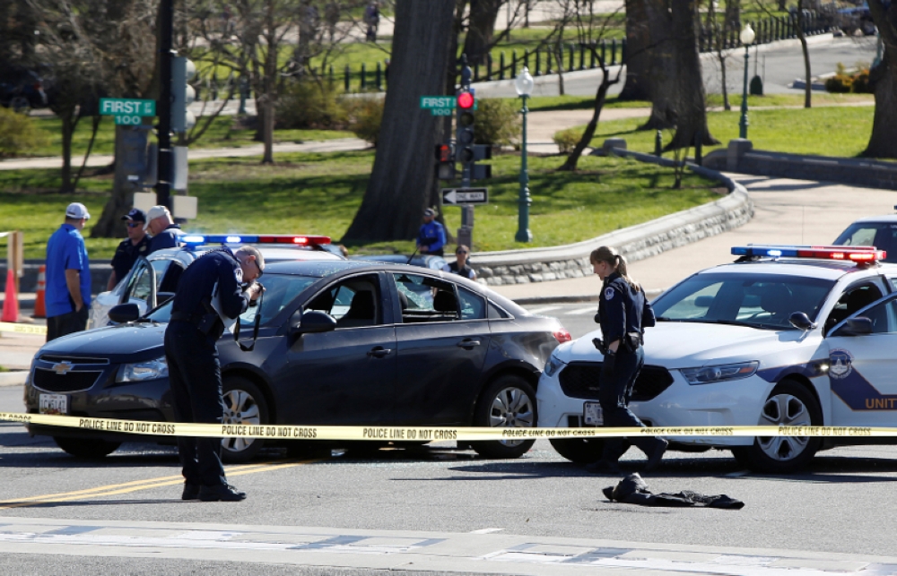 File photo of Capitol Hill police inspecting a car whose driver struck a Capitol Police cruiser and then tried to run over officers, near the US Capitol in Washington March 29, 2017. - Reuters pic