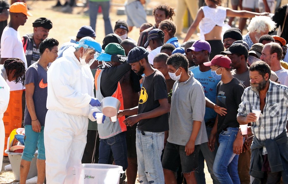 File photo of homeless people queueing for food at a camp set up by disaster management authorities during the 21-day nationwide lockdown aimed at limiting the spread of coronavirus disease (Covid-19) in Cape Town, South Africa, April 9, 2020. - Reuters pic