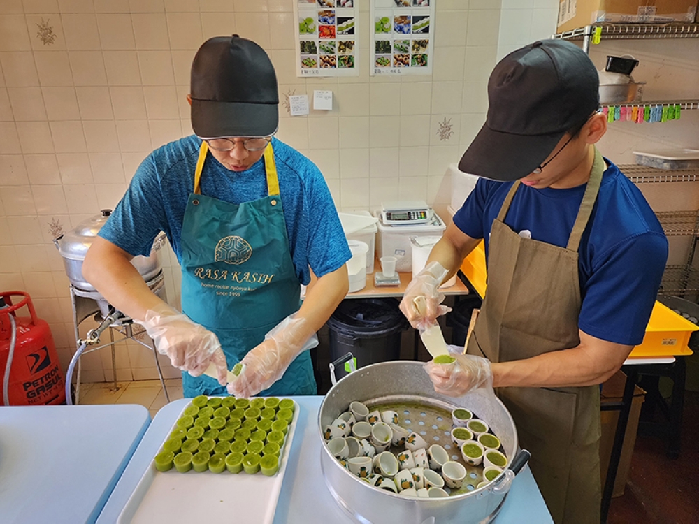 Baylon Tham and Cheng Wei Da making 'kuih kosui'. — Pictures courtesy of Kenny Loh 