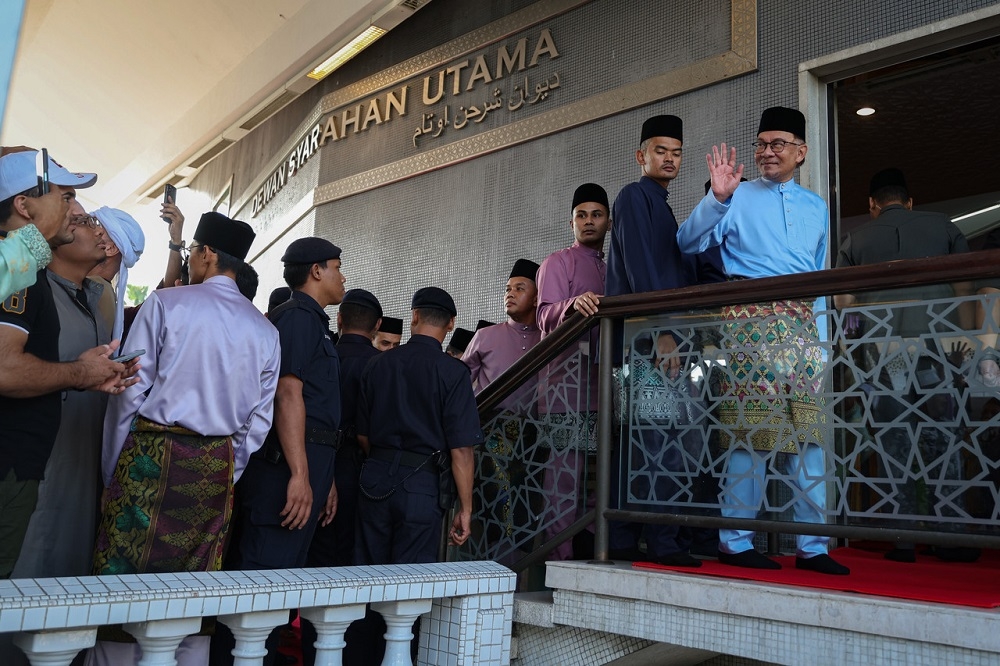 Prime Minister Datuk Seri Anwar Ibrahim waves at the crowd after performing the Aidilfitri prayers at the National Mosque in Kuala Lumpur April 22, 2023. — Bernama pic