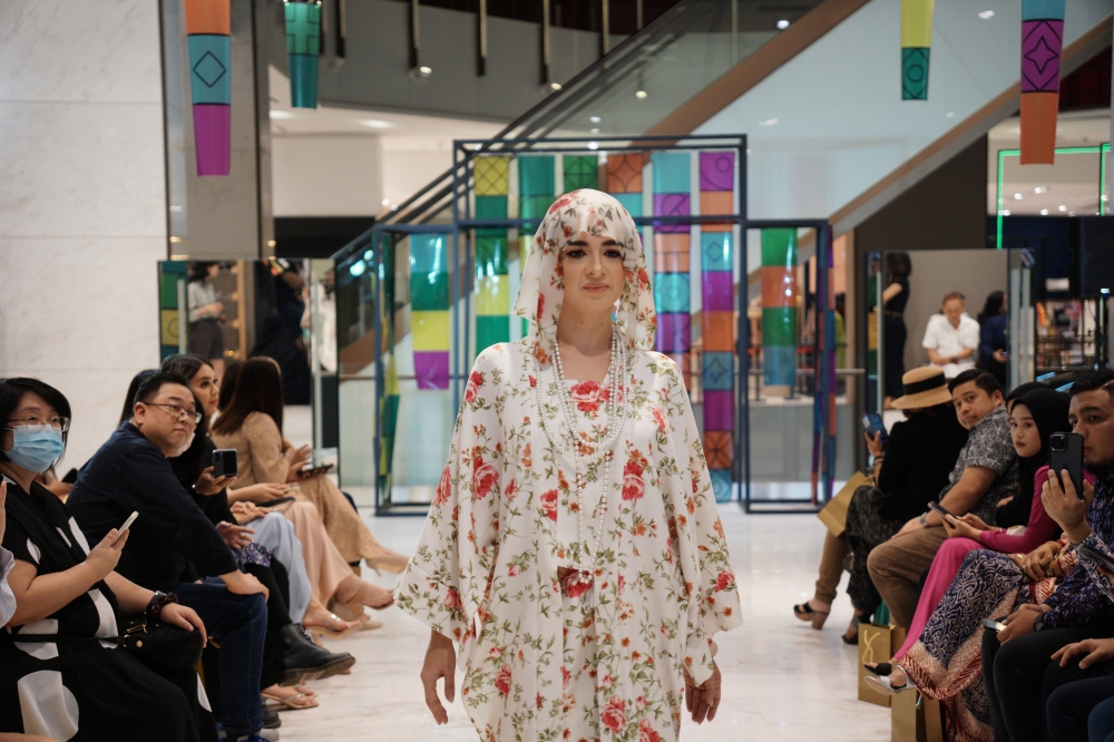 A modern kebaya top and sarong in English floral print with matching headscarf from Zaff Ben Jibby. — Picture courtesy of CollabStore