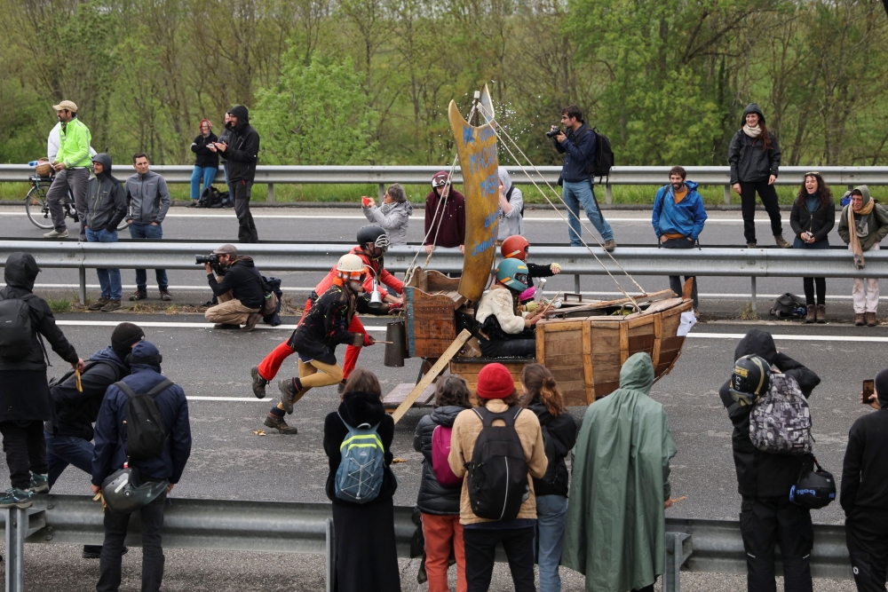 Activists gather to protest against a highway project between Toulouse and Castres, which worry environmental activists to see hundreds of hectares of agricultural land and trees disappear, near the village of Saix, France, April 22, 2023. — Reuters pic