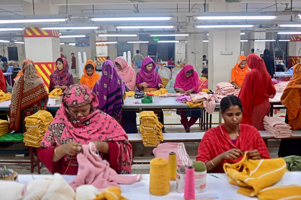In this photograph taken on April 13, 2023, women work at a garment factory in Savar, on the outskirts of Dhaka. — AFP pic