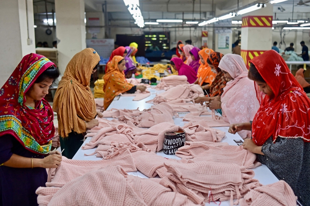 In this photograph taken on April 13, 2023, women work at a garment factory in Savar, on the outskirts of Dhaka. — AFP pic