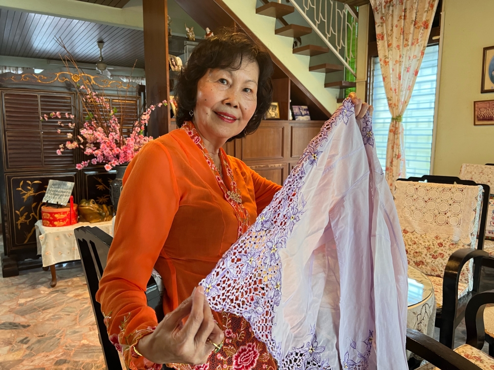 Susan with a Nyonya 'kebaya' that her mother made.  — Picture by Opalyn Mok