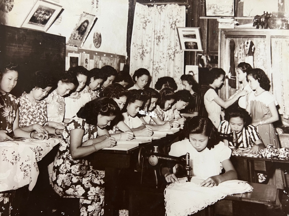 Lim Geok Mui (centre) with her students, all of them wearing 'kebayas' they learnt to make in her tailoring school. — Picture courtesy of Susan Tan