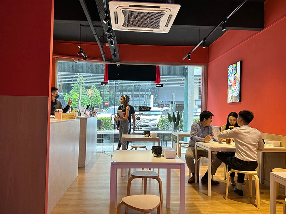 The eatery gets crowded during lunch time with various office workers.