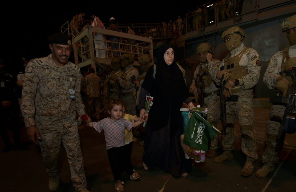 Saudi citizens and other nationals arrive at King Faisal navy base in Jeddah, following their rescue from Sudan. — AFP pic