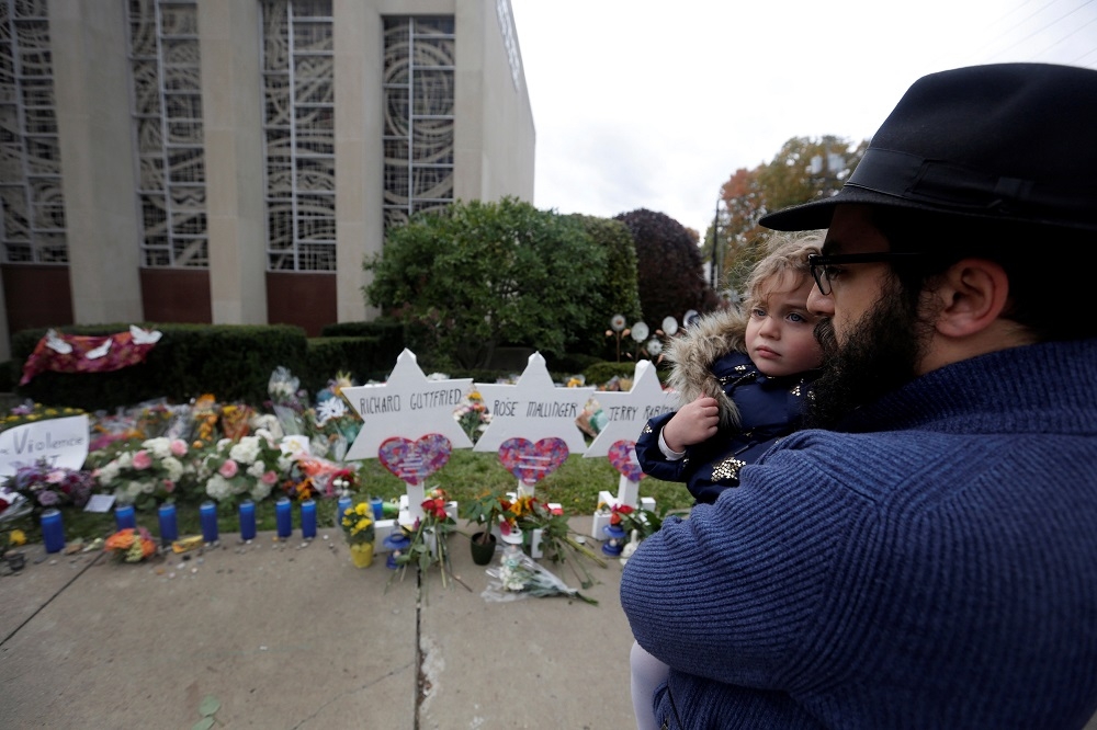 File photo of a man praying outside the Tree of Life synagogue following the shooting at the synagogue in Pittsburgh, Pennsylvania October 29, 2018. — Reuters pic 