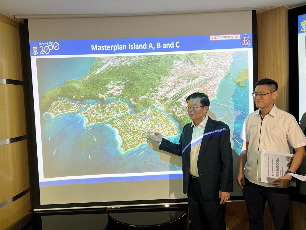 Penang Chief Minister Chow Kon Yeow (left) and state exco Zairil Khir Johari showing the artists’ impression of the PSI project on April 26, 2023. ― Picture by Opalyn Mok
