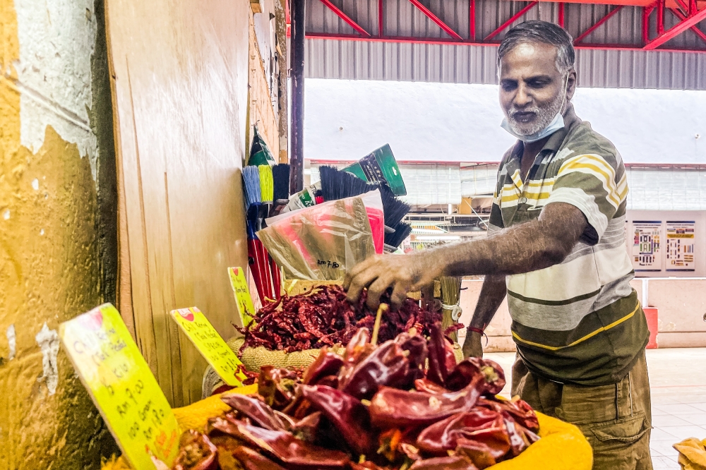 Chilli trader Palani Velu, 55, says dried chillies are usually sold in three categories: non-spicy, less spicy and spicy. — Picture by Hari Anggara