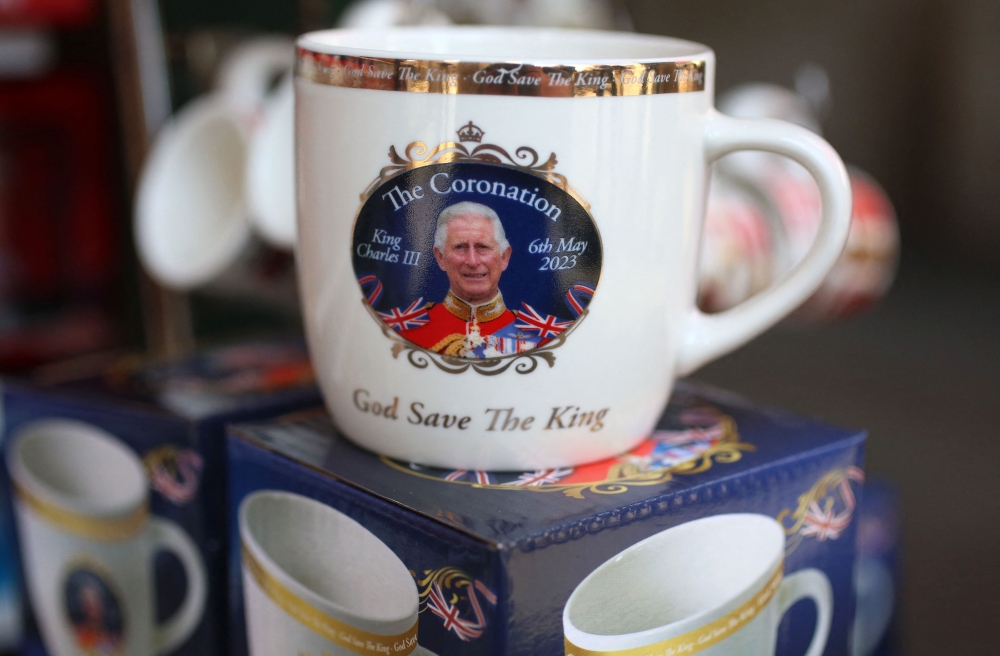 Royal souvenirs are seen for sale on a stall in central London on April 29, 2023 ahead of the coronation ceremony of Charles III and his wife, Camilla, as King and Queen of the United Kingdom and Commonwealth Realm nations, on May 6, 2023. — AFP pic