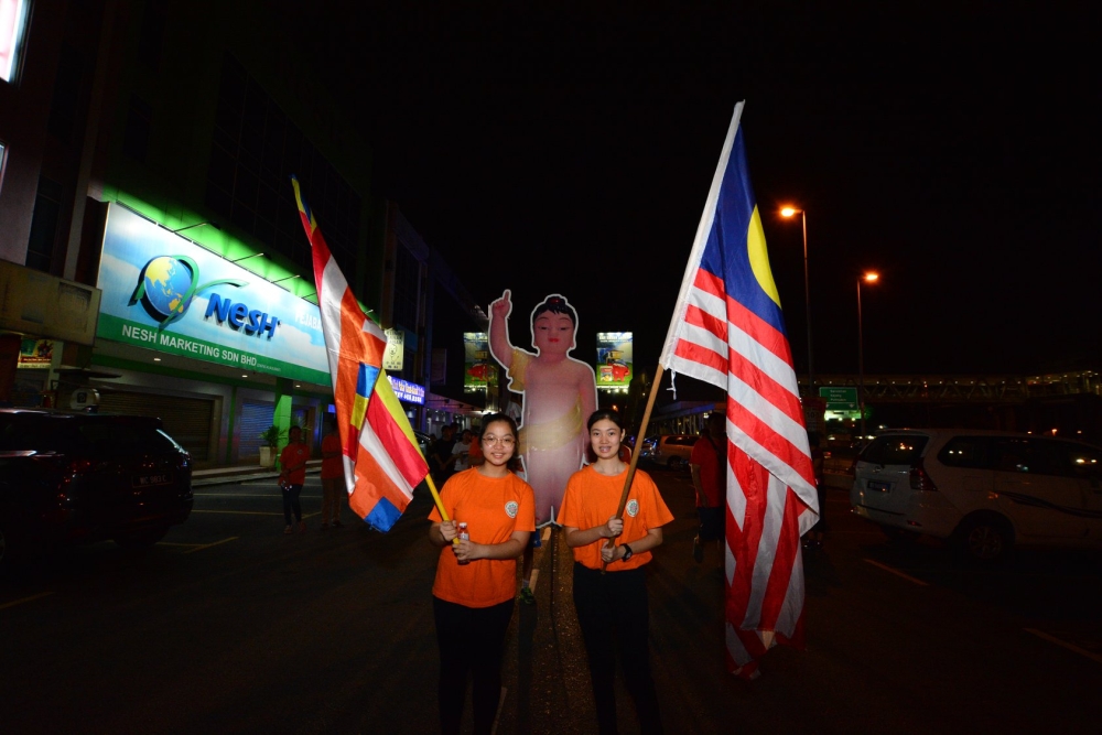 Young devotees carry the Jalur Gemilang and the Buddhist Flag during the 2019 Wesak float procession. — Picture courtesy of Ti-Ratana Buddhist Society