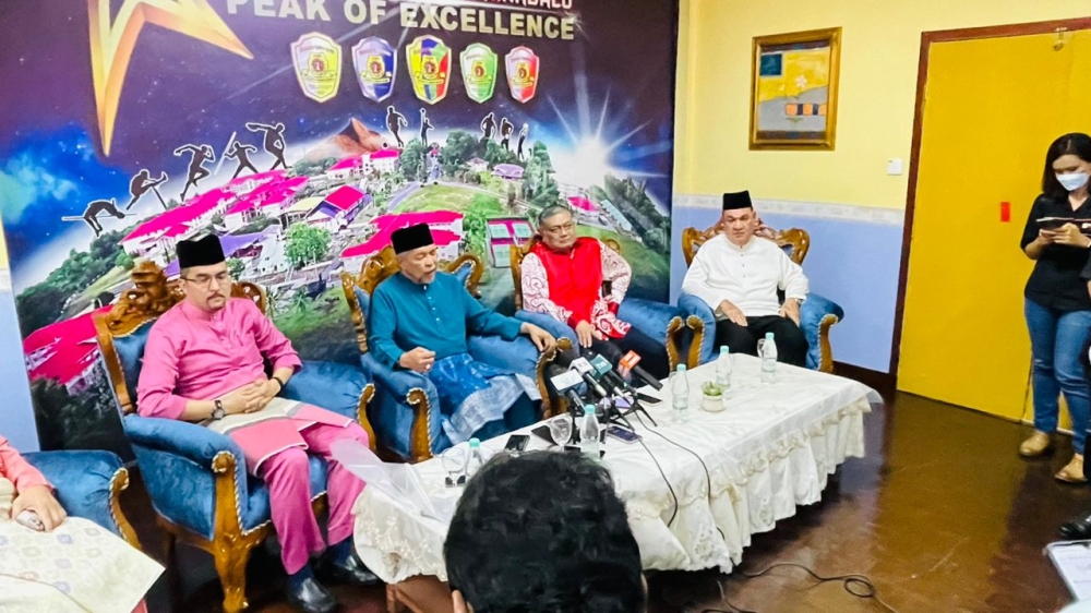 Zahid (seated, centre) renamed the MRSM in Kota Kinabali after former Sabah chief minister Tan Sri Musa Aman who was absent during the event today. — Picture by Julia Chan