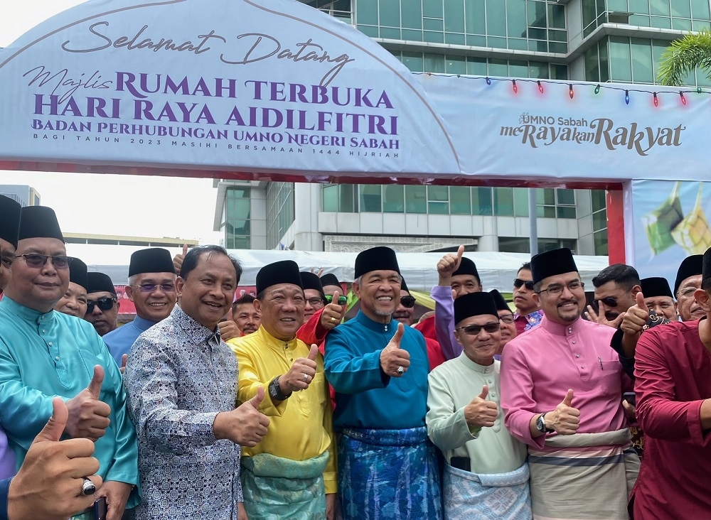 Jaujan (second, left) with Bung (third, left) and Zahid (centre) at the Umno open house in Kota Kinabalu today. ― Picture by Julia Chan