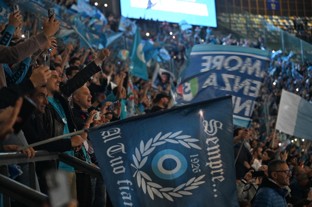 Fans of SSC Napoli cheer at the Maradona stadium on May 4, 2023 in Naples, where fans are gathered to watch on a giant screen the live broadcast of the match between Udinese and Napoli played in Uddine. — AFP pic