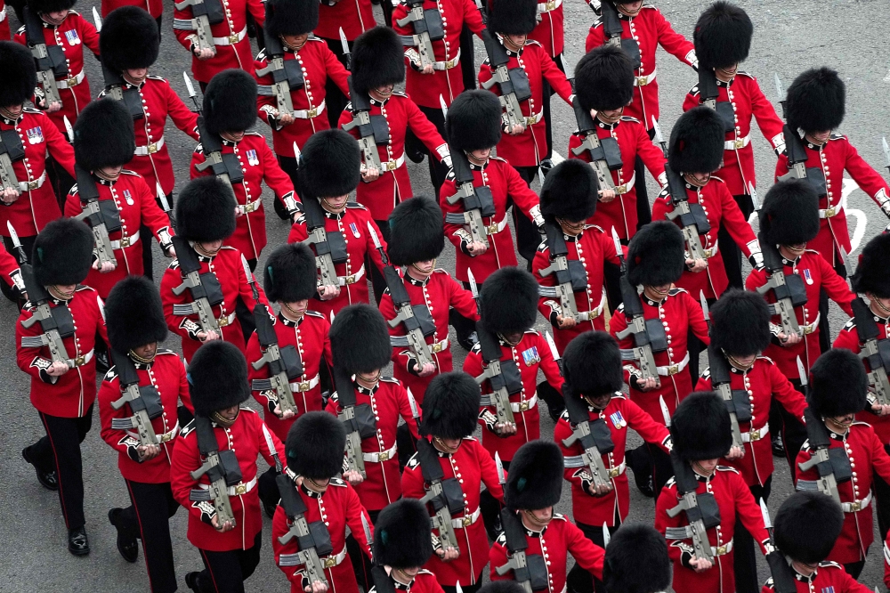 Coldstream Guards march along the route of the ‘King’s Procession’, a two kilometres stretch from Buckingham Palace to Westminster Abbey, in central London, on May 6, 2023 ahead of the Coronation of King Charles III. — AFP pic