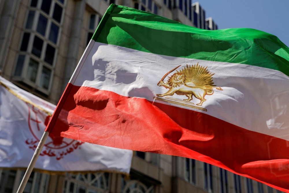 File photo of a flag is waved in front of Palais Coburg where closed-door nuclear talks with Iran take place in Vienna, Austria, August 4,2022. — Reuters pic
