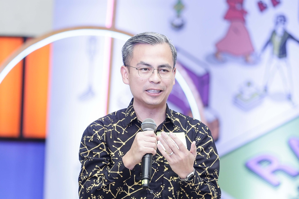 Minister of Communication Fahmi Fadzil delivers his speech at the 2023 Raya +Fluencer at Telekom Museum. — Picture by Sayuti Zainudin 
