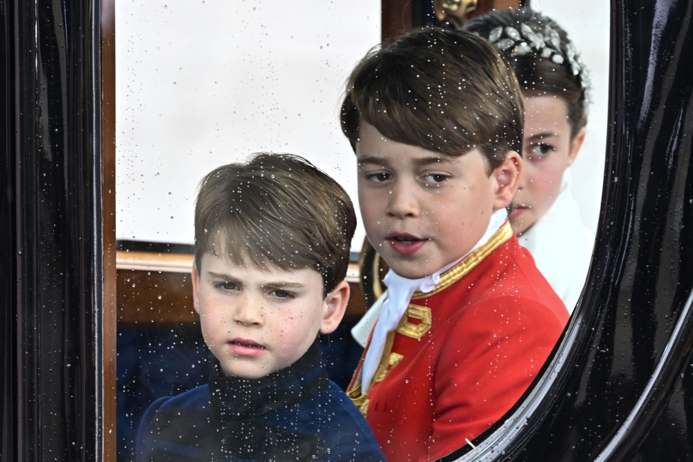 Britain’s Prince Louis of Wales, Britain's Prince George of Wales and Britain’s Princess Charlotte of Wales travel back to Buckingham Palace from Westminster Abbey in central London on May 6, 2023, after the coronations of Britain's King Charles III and Britain’s Queen Camilla. — AFP pic