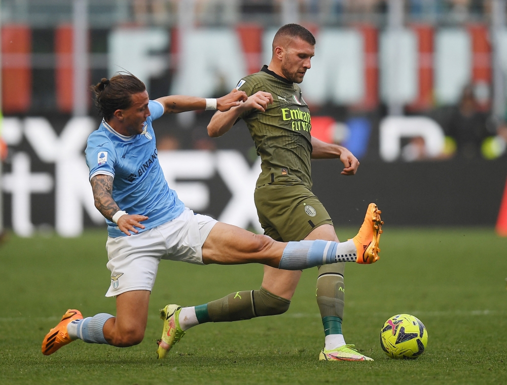 Lazio’s Luca Pellegrini in action with AC Milan’s Ante Rebic at the San Siro stadium in Milan, May 6, 2023. — Reuters pic