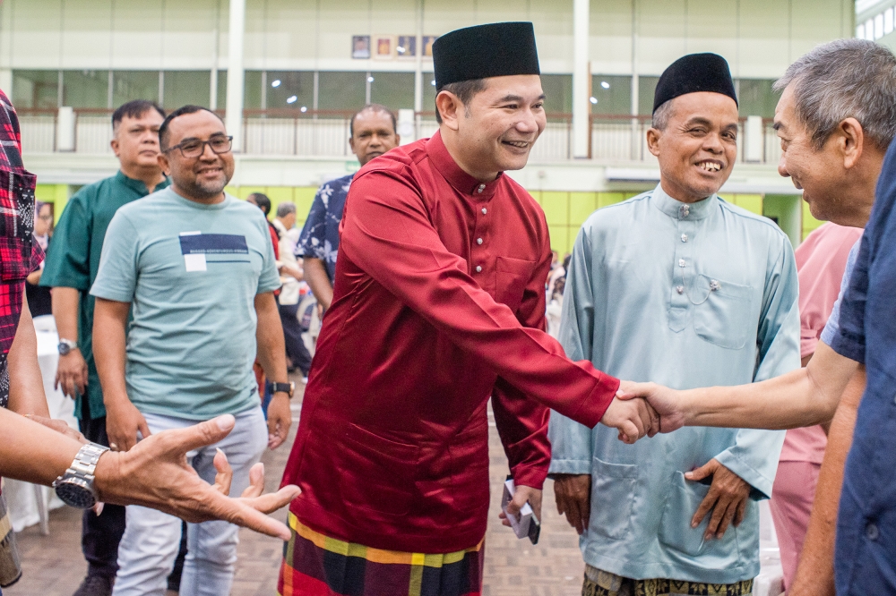 Minister of Economic Affairs, Rafizi Ramli sharing a light moment with people attending the Pandan parliament constituency Aidilfitri open house at Pandan Indah, Ampang, May 7, 2023. — Picture by Shafwan Zaidon
