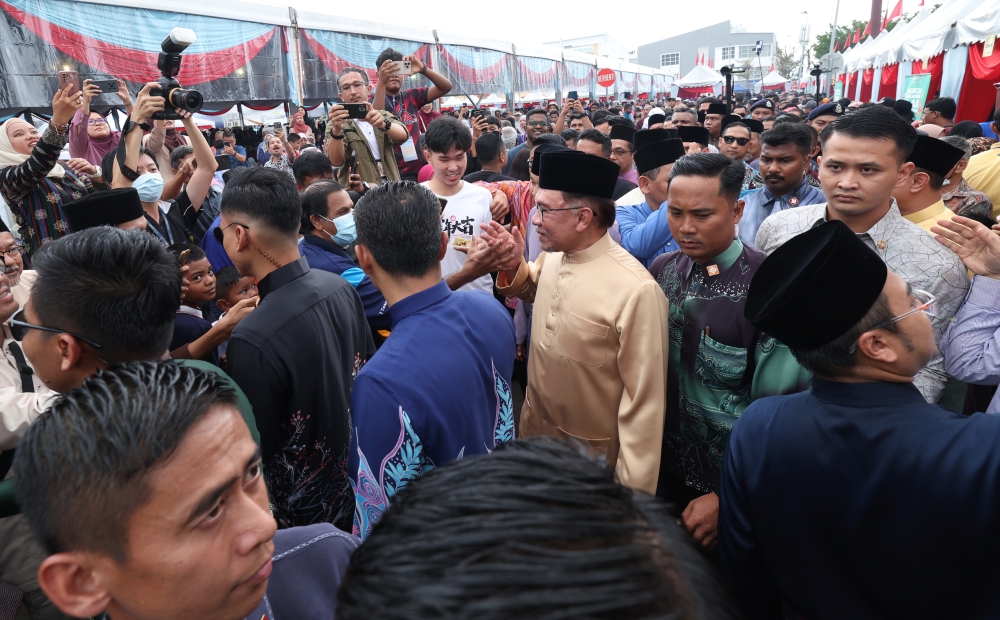 Prime Minister Datuk Seri Anwar Ibrahim shaking hands with the crowd when he attends the Negri Sembilan and Malaysia Madani Aidilfitri Open House at Wisma City Council Seremban (MBS), in Seremban, May 7, 2023. — Bernama pic
