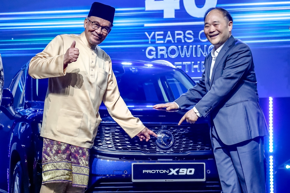Prime Minister Datuk Seri Anwar Ibrahim and Chairman of Geely Holding Group, Eric Li, during the official launching ceremony of the Proton X90 at MITEC in Kuala Lumpur May 7, 2023. — Picture by Firdaus Latif
